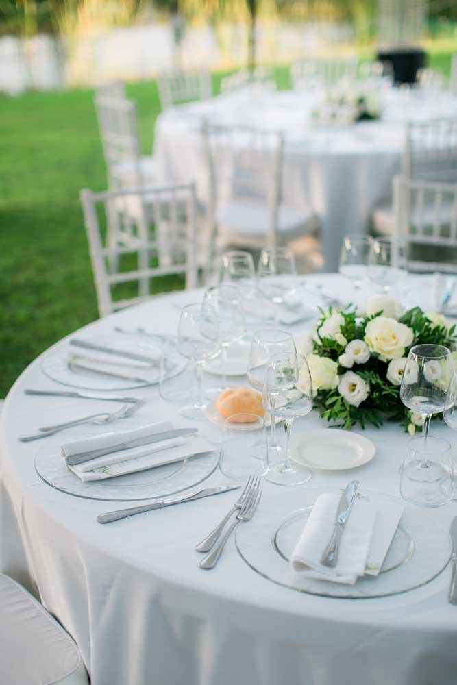 Tavola allestita per matrimonio all'aperto.